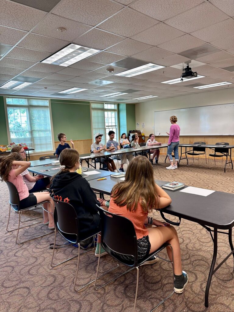 Alex Evanovich at the whiteboard leading the library's creative writing workshop for teens.