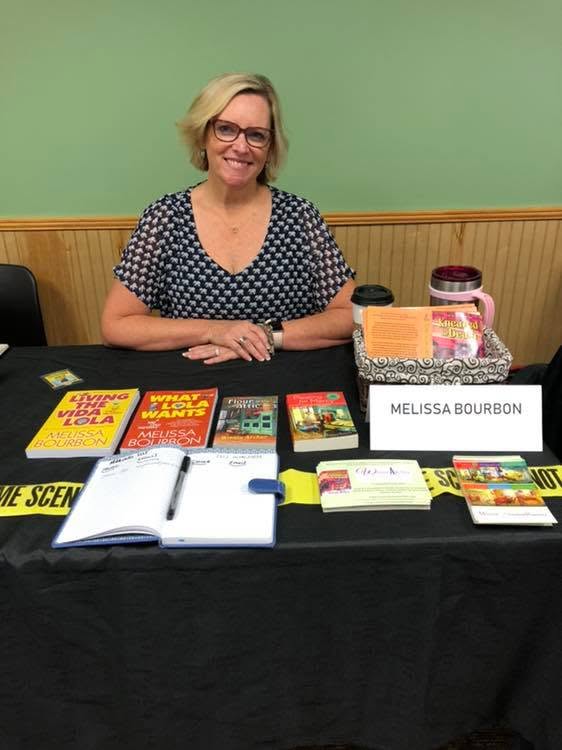 Melissa Bourbon at her mystery table at the Local Author Book Fair.