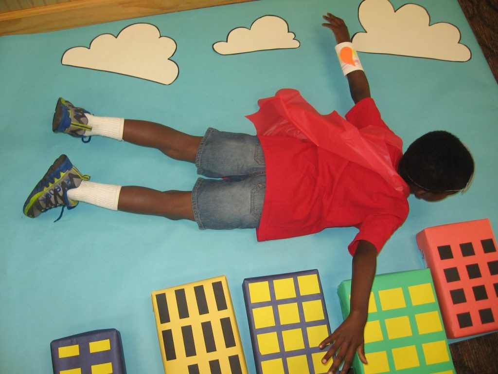 The photo booth: cape on, flying over the city